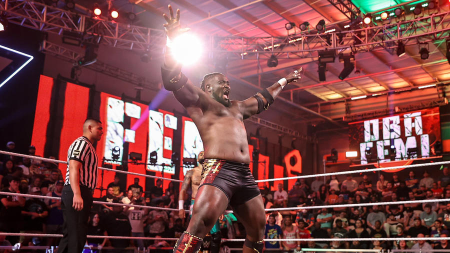 Oba Femi poses inside the WWE NXT ring.